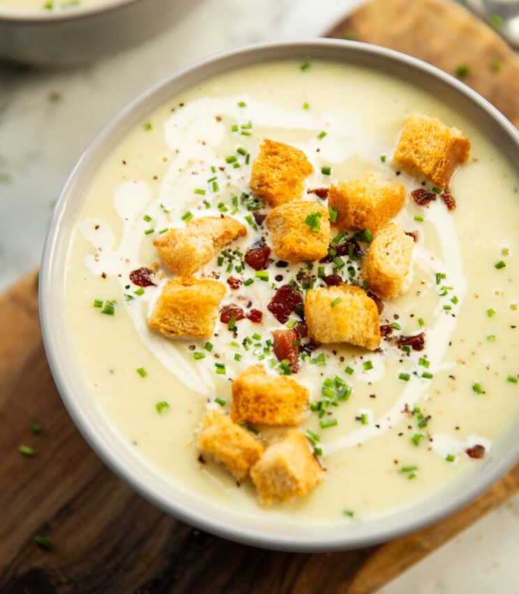 close up shot of potato leek soup in small white bowl
