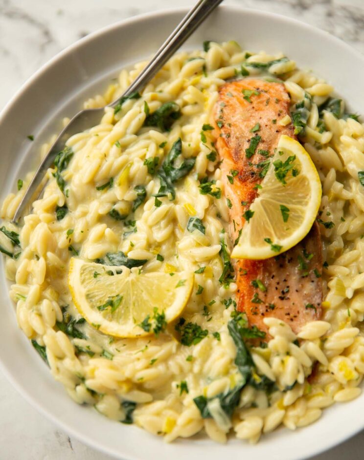 boursin salmon orzo served in large white bowl with silver fork