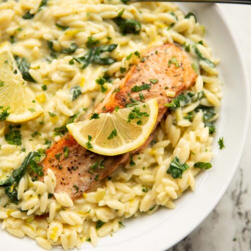 boursin salmon orzo served in large white bowl with lemon and fresh parsley