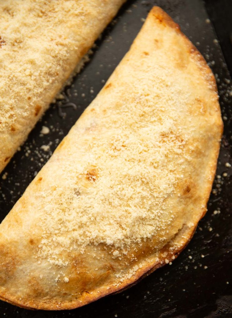close up over shot of tortilla wrap calzone fresh out the oven on baking tray