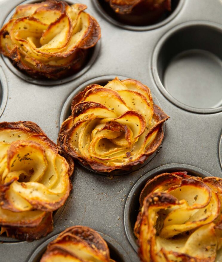 close up shot of potato roses in muffin tray fresh out the oven