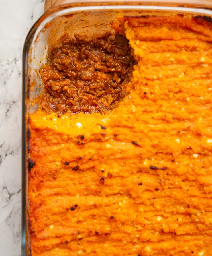 overhead shot of sweet potato shepherds pie with portion taken out showing filling