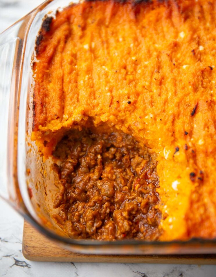 close up shot of sweet potato shepherds pie with portion scooped out showing filling