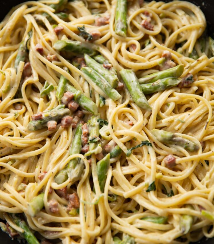 close up shot of asparagus pasta in large pan