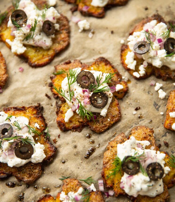 Greek potatoes on parchment paper with garnish